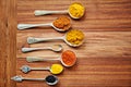 The perfect combination for a great curry. spoons filled with a variety of spices.