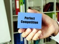 Perfect Competition sign on the blue business card