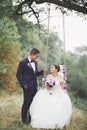 Perfect couple bride, groom posing and kissing in their wedding day