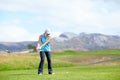 The perfect course to perfect my game. A young female golfer using a driver to hit a golf ball down the fairway towards Royalty Free Stock Photo