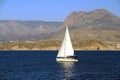 Sloop sailboat on a quiet sea in open waters. Royalty Free Stock Photo