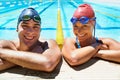 The perfect day for a swim. Two young swimmers smiling broadly at the camera as they stand in the pool. Royalty Free Stock Photo