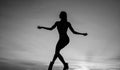 perfect female body. sensuality. female silhouette on sunset. woman dance in dark. Royalty Free Stock Photo