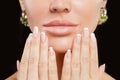 Perfect female hands with manicured nails and lips. French manicure and beige lipstick makeup Royalty Free Stock Photo