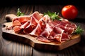 Sliced prosciutto on a wooden board