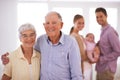 The perfect footsteps to follow in. Portrait of a happy senior couple with their adult children and their baby in the Royalty Free Stock Photo