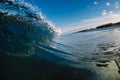 Perfect glassy wave in sea. Crashing surfing wave and sky