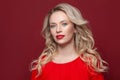 Perfect gorgeous fashion model woman with blonde curly hairdo and red lips makeup Royalty Free Stock Photo