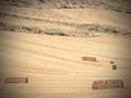 Perfect harvest landscape with straw bales amongst fields Royalty Free Stock Photo