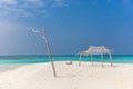 Perfect isolated island surrounded by a blue water sea, little hut, tree and blue sky day. Feeling of paradise, freedom, liberty. Royalty Free Stock Photo