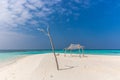 Perfect isolated island surrounded by a blue water sea, little hut, tree and blue sky day. Feeling of paradise, freedom, liberty. Royalty Free Stock Photo