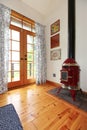 Perfect little red fireplace in hardwood room.