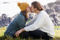 Perfect love. an affectionate young couple sharing a kiss while sitting on the grass. Royalty Free Stock Photo