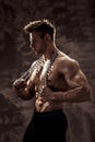 The Perfect male body - Awesome bodybuilder posing. Hold a chain with tattoo Royalty Free Stock Photo