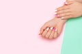 Perfect manicure with trendy nail art on pink and turqoise background