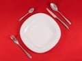 Perfect modern table setting on red napkin background