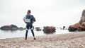 Perfect morning. Back view of strong and confident disabled woman in sportswear with prosthetic leg is standing on the Royalty Free Stock Photo