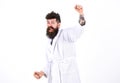 Perfect morning concept. Happy guy saluting with his raised arm. Cheerful man in white bathrobe standing in white room Royalty Free Stock Photo