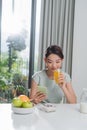 Perfect morning. Happy and positive woman eating breakfast while talking on her smartphone Royalty Free Stock Photo