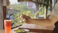 Perfect morning with a healthy breakfast for a happy female. Woman eating tropical smoothie bowl and drinking fresh Royalty Free Stock Photo