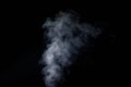 Perfect mystical curly white steam or smoke isolated on black background. Abstract background fog or smog