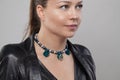 Perfect necklace with grey and blue pearls and silver leaves on neck of beautiful model woman