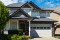 A perfect neighborhood. Houses in suburb at summer in the north America. Big custom houses with driveway to garage Royalty Free Stock Photo