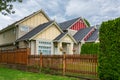 A perfect neighbourhood. Colorful residential houses with wooden fence in front