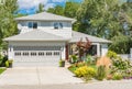 A perfect neighbourhood. Family house with landscaped front yard on sunny day in British Columbia Royalty Free Stock Photo