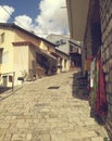Perfect old traditional street. souvenirs, houses and cky with clouds