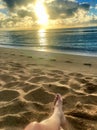 Perfect Paradise Feet up relaxing watching a glorious golden sunrise over the beach in Kauai Hawaii Royalty Free Stock Photo