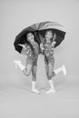 Perfect place to stay. small girl under colorful umbrella. two happy kids yellow background. children enjoy rainy autumn Royalty Free Stock Photo