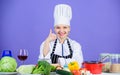 Perfect recipe. Turn ingredients into delicious meal. Culinary skills. Woman chef wear hat apron near table ingredients Royalty Free Stock Photo