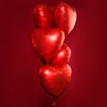 Perfect red heart balloons composition on bright red card background