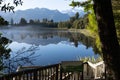 Perfect reflection in Lake Matheson surrounded by beautiful natural forest under blue sky Royalty Free Stock Photo