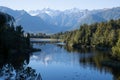 Perfect reflection in Lake Matheson surrounded by beautiful natural forest under blue sky Royalty Free Stock Photo