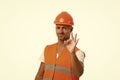 Perfect repairing guaranteed. man in helmet show ok gesture. successful worker in hardhat. wear hard hat to protect