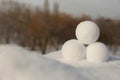 Perfect round snowballs on snow outdoors, closeup. Space for text