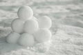 Perfect round snowballs on snow outdoors, closeup. Space for text