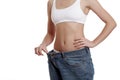 Perfect, slim, young body of a girl in white underwear. Weight loss and healthy eating. A woman in jeans of large size. The Royalty Free Stock Photo