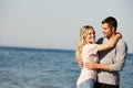 The perfect spot for a bit of loving. Portrait of a happy young couple hugging each other at the ocean. Royalty Free Stock Photo