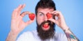 Perfect strawberry concept. Look at my berry. Man handsome hipster long beard eat hold strawberry. Hipster happy enjoy