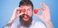 Perfect strawberry concept. Look at my berry. Man handsome hipster long beard eat hold strawberry. Hipster happy enjoy