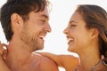 Perfect summer loving. Side view of a young couple standing face to face and being affectionate. Royalty Free Stock Photo