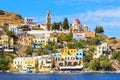 Perfect sunny day and beautiful view from the sea on colorful houses on rocks on Greek island Simi Symi , Dodecanesse