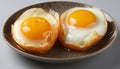 Perfect sunny side up eggs on a plate, with bright yolks and crispy edges