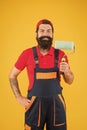 Perfect surface painting. Skillful painter. Bearded man painter on yellow background. Painting tool. Brush roller Royalty Free Stock Photo