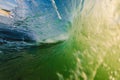 Perfect surfing swell in ocean. Barrel wave with morning warm light