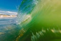 Perfect surfing swell in ocean. Barrel wave with morning warm light