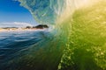 Perfect surfing swell in ocean. Barrel wave with morning warm light